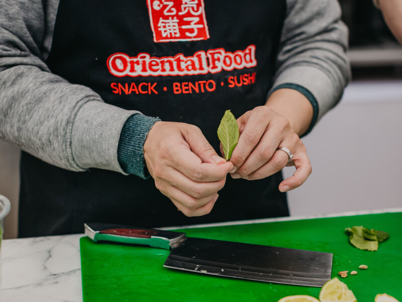 Close up of a person preparing various tea ingredients